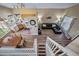 Open floor plan with kitchen, dining area, and living room, viewed from above the staircase at 5189 S Malta Way, Centennial, CO 80015