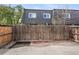 Fenced backyard with concrete and gravel area, providing a private outdoor space at 6711 S Race St, Centennial, CO 80122
