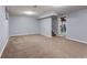 Spacious basement with neutral carpeting, ready for customization as a Gathering or rec room at 6711 S Race St, Centennial, CO 80122