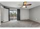This bedroom features carpeted floors, a sliding glass door and neutral walls at 6711 S Race St, Centennial, CO 80122
