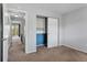 A bedroom with carpeted floors, built-in closet and neutral walls at 6711 S Race St, Centennial, CO 80122