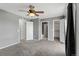 This bedroom features carpeted floors, a ceiling fan and neutral walls at 6711 S Race St, Centennial, CO 80122
