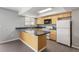 Functional kitchen with light wood cabinets, laminate countertops, and modern appliances at 6711 S Race St, Centennial, CO 80122