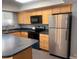 Well-lit kitchen features stainless steel refrigerator and ample cabinet space for storage at 6711 S Race St, Centennial, CO 80122