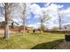 Large, fenced backyard with a well-maintained lawn and mature trees, great for outdoor activities at 5324 S Malta Way, Centennial, CO 80015