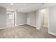 Finished basement featuring neutral carpeting, gray walls, and doorways to adjacent rooms at 5324 S Malta Way, Centennial, CO 80015