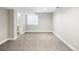 Basement with gray walls and neutral carpet, featuring a window and a doorway to a bathroom at 5324 S Malta Way, Centennial, CO 80015
