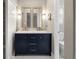Bright bathroom displaying double vanity with mirrors, modern fixtures, and decorative gold accents at 5324 S Malta Way, Centennial, CO 80015