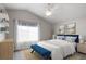 Serene bedroom with natural light, complemented by neutral tones, and a striking blue accent bench at 5324 S Malta Way, Centennial, CO 80015