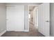 Bright bedroom featuring plush gray carpeting, white closet doors, and an open doorway at 5324 S Malta Way, Centennial, CO 80015