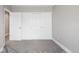 Bedroom featuring sliding-door closet with carpet flooring and neutral paint for a bright interior at 5324 S Malta Way, Centennial, CO 80015
