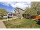 Charming exterior view of the home with a well-kept lawn and 'For Sale' sign in the front yard at 5324 S Malta Way, Centennial, CO 80015