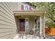 Inviting front porch with stylish details, including a decorative door, complementary sidelight, and stone accents at 5324 S Malta Way, Centennial, CO 80015