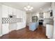 Modern kitchen featuring white cabinets, stainless steel appliances, a granite island, and stylish backsplash at 5324 S Malta Way, Centennial, CO 80015