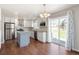 Updated kitchen featuring stainless steel appliances, granite countertops, a kitchen island, and a sliding glass door at 5324 S Malta Way, Centennial, CO 80015