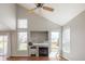 Bright living room with vaulted ceilings, a fireplace with stone accents, and ample natural light from large windows at 5324 S Malta Way, Centennial, CO 80015