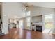 Open-concept living room showcasing hardwood floors, a fireplace, and seamless transition to the modern kitchen at 5324 S Malta Way, Centennial, CO 80015