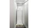 Shower with a glass door and white tiles, accented by a colorful tiled base at 5324 S Malta Way, Centennial, CO 80015