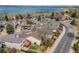 An aerial view of a neighborhood, showcasing its location near a large lake and green spaces at 10436 W 84Th Pl, Arvada, CO 80005