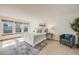 Bright bedroom featuring three windows, carpet, and tasteful decor, creating a comfortable and inviting space at 10436 W 84Th Pl, Arvada, CO 80005