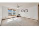Bedroom featuring two large windows, neutral carpet, and a ceiling fan at 10436 W 84Th Pl, Arvada, CO 80005
