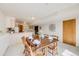 Dining area features neutral carpet, adjacent to the kitchen, with a table set for dinner at 10436 W 84Th Pl, Arvada, CO 80005