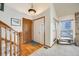 Inviting foyer with hardwood floors, a staircase, and a bright window at 10436 W 84Th Pl, Arvada, CO 80005