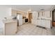 Bright kitchen features neutral cabinets, white appliances, and tile flooring at 10436 W 84Th Pl, Arvada, CO 80005