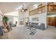 Expansive living room with high ceilings, a loft, and a cozy fireplace at 10436 W 84Th Pl, Arvada, CO 80005