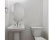 Simple bathroom with pedestal sink and oval mirror at 5091 Hickory Oaks St, Castle Rock, CO 80104