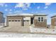 Two-story house with a two-car garage and stone accents at 5091 Hickory Oaks St, Castle Rock, CO 80104