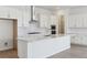Modern kitchen with white cabinets and island at 5091 Hickory Oaks St, Castle Rock, CO 80104