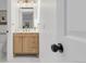 Modern bathroom features a wood vanity, gold fixtures and bull art at 1260 Ascot Ave, Highlands Ranch, CO 80126
