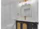 Modern bathroom features a unique vanity with gold accents and tile floor at 1260 Ascot Ave, Highlands Ranch, CO 80126