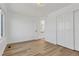 Bedroom with wood floors, a window, and an ensuite bathroom at 1260 Ascot Ave, Highlands Ranch, CO 80126