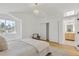 Bright primary bedroom features a vaulted ceiling, skylight, and a glimpse of the bathroom at 1260 Ascot Ave, Highlands Ranch, CO 80126