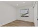 Bright bedroom with a large window offering natural light and wood floors at 1260 Ascot Ave, Highlands Ranch, CO 80126