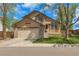 Inviting two-story home with a lush green lawn, attached two-car garage, and a well-maintained yard at 1260 Ascot Ave, Highlands Ranch, CO 80126