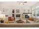 Cozy living room featuring a stone fireplace, built-in shelving, and comfortable seating at 12447 W 77Th Ave, Arvada, CO 80005