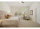 Bright and airy main bedroom featuring soft carpet, neutral tones, and three large windows at 12447 W 77Th Ave, Arvada, CO 80005