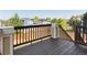 Wooden deck overlooking backyard with fence for privacy and blue skies above at 4816 S Elk Way, Aurora, CO 80016