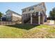 Large grassy backyard with brick house and wooden fence at 4816 S Elk Way, Aurora, CO 80016