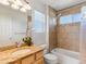 Bright bathroom featuring tile floors, granite counters and a tub/shower combo at 4816 S Elk Way, Aurora, CO 80016