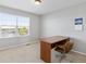 Bright bedroom featuring a modern desk, comfortable chair and large sunny window at 4816 S Elk Way, Aurora, CO 80016