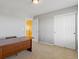 Neutral bedroom with large closet, adjacent yellow wall, and a light fixture at 4816 S Elk Way, Aurora, CO 80016