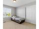 Bedroom with a sunny window, neutral carpet and a closet with sliding doors at 4816 S Elk Way, Aurora, CO 80016