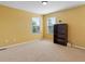 Bright bedroom with neutral carpet, sunny windows and a dark wood bookcase at 4816 S Elk Way, Aurora, CO 80016