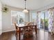 Cozy dining area with hardwood floors, pendant lighting and view of the outside deck at 4816 S Elk Way, Aurora, CO 80016