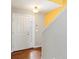 Bright foyer featuring hardwood floors, a white front door, and a staircase at 4816 S Elk Way, Aurora, CO 80016