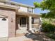 Inviting front porch with brick accents, white columns, and a cozy seating area at 4816 S Elk Way, Aurora, CO 80016